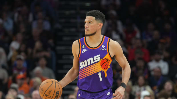 Phoenix Suns guard Devin Booker dribbles the basketball.